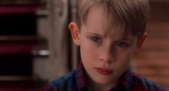 Movie still from “Home Alone” (1990), directed by Chris Columbus – A young boy with blue eyes; Close Up shot, Low angle