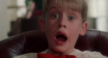 Movie still from “Home Alone” (1990), directed by Chris Columbus – A child with a surprised look on his face; Close Up shot, Low angle