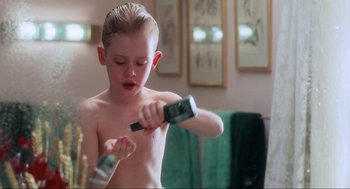 Movie still from “Home Alone” (1990), directed by Chris Columbus – A young boy brushing his teeth in the bathroom; Medium shot, Low angle