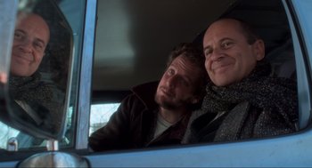 Movie still from “Home Alone” (1990), directed by Chris Columbus – Two men sitting in the back seat of a car; Close Up shot, Low angle