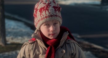 Movie still from “Home Alone” (1990), directed by Chris Columbus – A young boy wearing a red and white hat and scarf; Close Up shot, Low angle