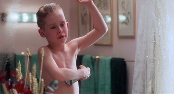 Movie still from “Home Alone” (1990), directed by Chris Columbus – A young boy in the bathroom brushing his teeth; Medium shot, Low angle