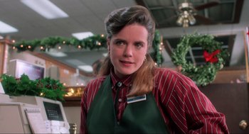 Movie still from “Home Alone” (1990), directed by Chris Columbus – A woman wearing a green and red striped shirt and apron; Close Up shot, Low angle