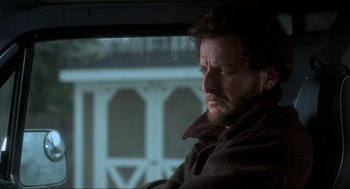 Movie still from “Home Alone” (1990), directed by Chris Columbus – A person sitting in a car; Close Up shot, Low angle