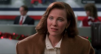 Movie still from “Home Alone” (1990), directed by Chris Columbus – A woman that is wearing a brown coat; Close Up shot, Over the shoulder angle