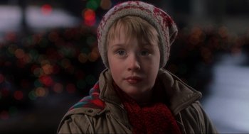 Movie still from “Home Alone” (1990), directed by Chris Columbus – A young boy wearing a winter hat and scarf; Close Up shot, Low angle