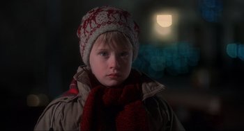 Movie still from “Home Alone” (1990), directed by Chris Columbus – A young boy wearing a winter hat and scarf; Close Up shot, Low angle