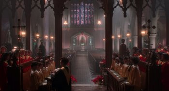 Movie still from “Home Alone” (1990), directed by Chris Columbus – A group of people sitting in a large church; Extreme Wide shot, High angle