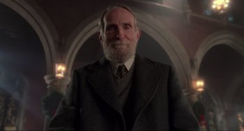 Movie still from “Home Alone” (1990), directed by Chris Columbus – An old man with a beard wearing a suit and tie; Close Up shot, Low angle