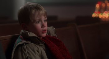 Movie still from “Home Alone” (1990), directed by Chris Columbus – A young boy wearing a jacket and a red scarf; Close Up shot, Low angle