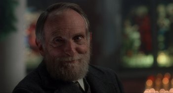 Movie still from “Home Alone” (1990), directed by Chris Columbus – An old man with a beard and a suit; Close Up shot, Over the shoulder angle