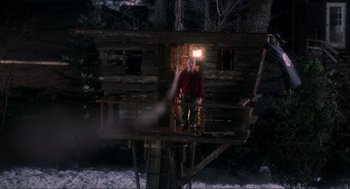 Movie still from “Home Alone” (1990), directed by Chris Columbus – A man and a woman standing on a porch of a log cabin; Wide shot, Low angle