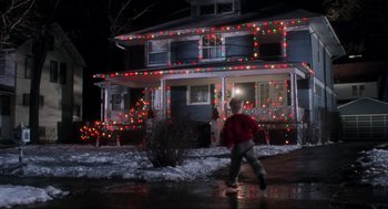 Movie still from “Home Alone” (1990), directed by Chris Columbus – A person walking in front of a house at night; Extreme Wide shot, Low angle