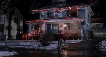 Movie still from “Home Alone” (1990), directed by Chris Columbus – A person walking in front of a house at night; Extreme Wide shot, Low angle
