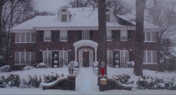 Movie still from “Home Alone” (1990), directed by Chris Columbus – A large brick house in the middle of a snow covered yard; Extreme Wide shot, Low angle