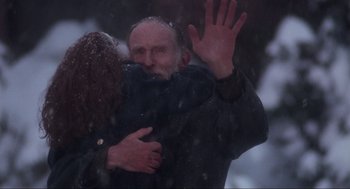 Movie still from “Home Alone” (1990), directed by Chris Columbus – An older man and a younger woman hugging in the snow; Medium shot, Over the shoulder angle