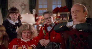 Movie still from “Home Alone 2: Lost in New York” (1992), directed by Chris Columbus – A boy and a woman sitting on a chair; Medium shot, High angle