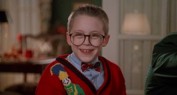 Movie still from “Home Alone 2: Lost in New York” (1992), directed by Chris Columbus – A young boy wearing glasses and a bow tie; Close Up shot, Low angle