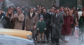Movie still from “Home Alone 2: Lost in New York” (1992), directed by Chris Columbus – A group of people walking down a street; Wide shot, Low angle