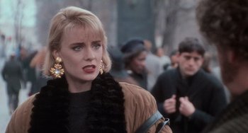 Movie still from “Home Alone 2: Lost in New York” (1992), directed by Chris Columbus – A person walking on the street; Close Up shot, Over the shoulder angle
