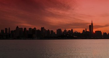 Movie still from “Home Alone 2: Lost in New York” (1992), directed by Chris Columbus – A view of a city skyline at sunset from across a body of water; Extreme Wide shot, Low angle