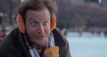 Movie still from “Home Alone 2: Lost in New York” (1992), directed by Chris Columbus – A person wearing ear muffs; Close Up shot, Low angle