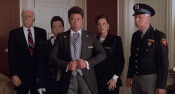 Movie still from “Home Alone 2: Lost in New York” (1992), directed by Chris Columbus – A group of men and women standing around each other; Medium shot, Low angle