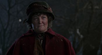 Movie still from “Home Alone 2: Lost in New York” (1992), directed by Chris Columbus – A woman wearing a red coat and a green hat; Close Up shot, Low angle