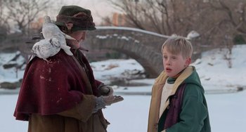 Movie still from “Home Alone 2: Lost in New York” (1992), directed by Chris Columbus – A woman and a boy are standing in the snow; Medium shot, Over the shoulder angle