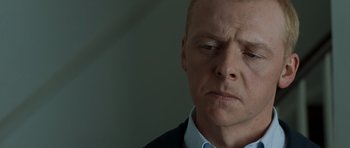 Movie still from “Hot Fuzz” (2007), directed by Edgar Wright – A person wearing a suit and tie; Close Up shot, Over the shoulder angle