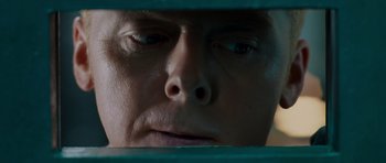 Movie still from “Hot Fuzz” (2007), directed by Edgar Wright – A person looking at his reflection in a mirror; Close Up shot, Overhead angle