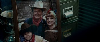 Movie still from “Hot Fuzz” (2007), directed by Edgar Wright – An old photo of a man and a woman in western garb; Extreme Close Up shot, High angle