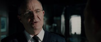 Movie still from “Hot Fuzz” (2007), directed by Edgar Wright – An older man wearing glasses and a tie; Close Up shot, Over the shoulder angle