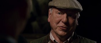 Movie still from “Hot Fuzz” (2007), directed by Edgar Wright – An older man wearing a hat and a jacket; Close Up shot, Low angle