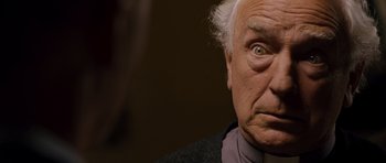 Movie still from “Hot Fuzz” (2007), directed by Edgar Wright – An older man with a surprised look on his face; Close Up shot, Low angle
