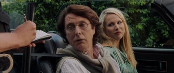 Movie still from “Hot Fuzz” (2007), directed by Edgar Wright – A man and a woman sitting next to each other in a car; Close Up shot, Over the shoulder angle