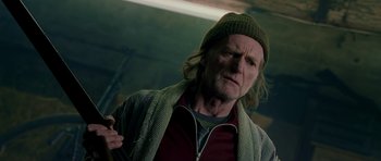 Movie still from “Hot Fuzz” (2007), directed by Edgar Wright – An older man with a beard and a hat; Close Up shot, Low angle