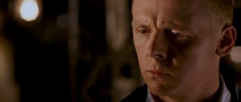 Movie still from “Hot Fuzz” (2007), directed by Edgar Wright – A person wearing a suit and tie; Close Up shot, Low angle