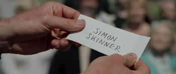 A person holding a piece of paper in their hand