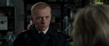 Movie still from “Hot Fuzz” (2007), directed by Edgar Wright – A person wearing a uniform; Close Up shot, Over the shoulder angle
