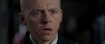 Movie still from “Hot Fuzz” (2007), directed by Edgar Wright – A man's face as he stares at the camera; Close Up shot, Low angle