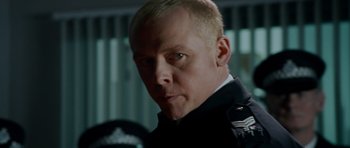 Movie still from “Hot Fuzz” (2007), directed by Edgar Wright – A person wearing a uniform; Close Up shot, Over the shoulder angle