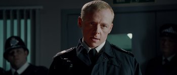 Movie still from “Hot Fuzz” (2007), directed by Edgar Wright – A person wearing a uniform; Close Up shot, Low angle