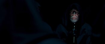 Movie still from “Hot Fuzz” (2007), directed by Edgar Wright – An old man with a beard and glasses in the dark; Medium shot, Over the shoulder angle