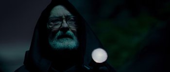 Movie still from “Hot Fuzz” (2007), directed by Edgar Wright – An old man with a beard and a hood on; Close Up shot, Low angle