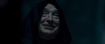Movie still from “Hot Fuzz” (2007), directed by Edgar Wright – An old man wearing a hood and smiling for the camera; Extreme Close Up shot, Low angle