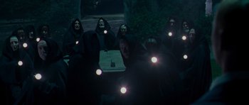 Movie still from “Hot Fuzz” (2007), directed by Edgar Wright – A group of people with lights on their heads; Wide shot, High angle