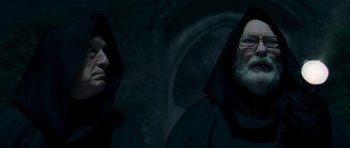 Movie still from “Hot Fuzz” (2007), directed by Edgar Wright – Two men in black robes and one is wearing glasses; Close Up shot, Low angle