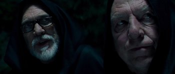 Movie still from “Hot Fuzz” (2007), directed by Edgar Wright – Two men in black hoods are looking at each other; Close Up shot, Over the shoulder angle