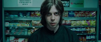 Movie still from “Hot Fuzz” (2007), directed by Edgar Wright – A man with long dark hair is staring straight ahead; Close Up shot, Low angle